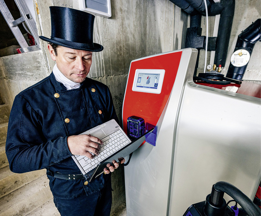 Ein Schornsteinfeger misst die Emissionen eines Holzkessels.