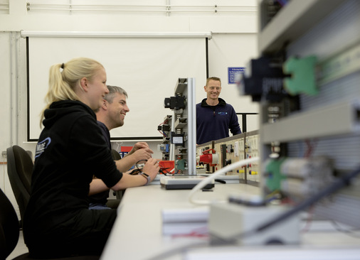 Innovationen für Sicherheit und Ergonomie: Training Fachkraft Elektrotechnik bei Offtec (oben links), hydraulischer Schrauber mit Akku, der den Transport eines schweren, sehr langen Stromkabels erübrigt (oben rechts), automatisches Steigsystem mit akkubetriebenem, kabinenlosem Lift an einer Schiene, an der auch der Fallschutzläufer des Personals  andockt (unten links und rechts). Die Schiene lässt sich aber auch statt der Leiter zum sprossenfreien Aufstieg mit Spezialrollenschuhen nutzen.