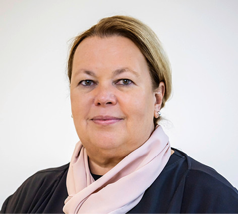 Eine Frau mit hellbraunem Haar, die einen rosa Schal und ein dunkles Oberteil trägt, posiert vor einem schlichten Hintergrund. - © Foto: BEE / Rolf Schulten