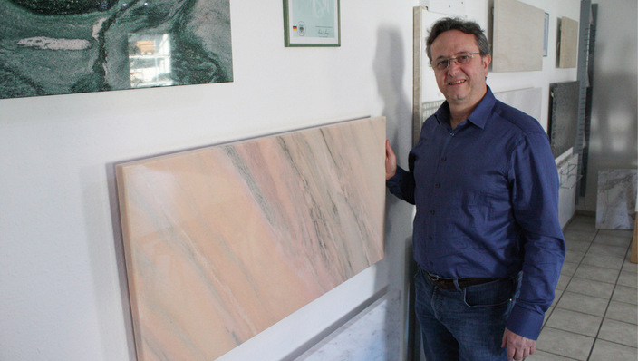 Geschäftsführer Akritas Sidiropoulos präsentiert Heizplatten aus Marmor.